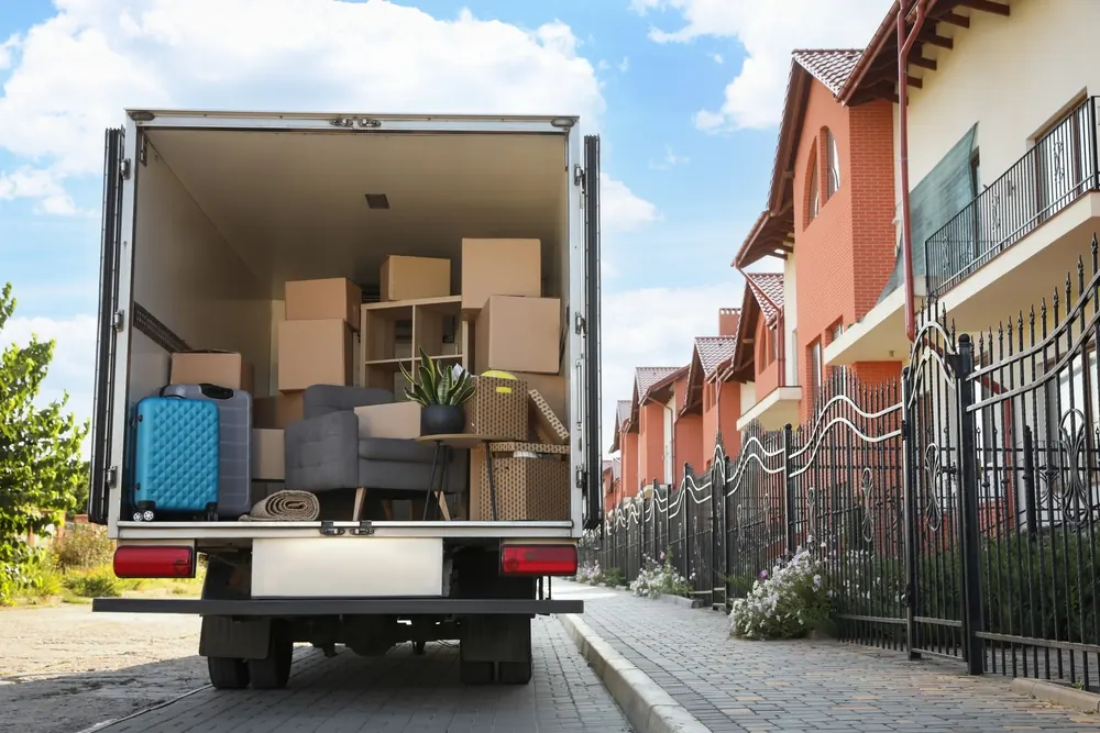 Delivery truck loaded with furniture and boxes parked outside a customer's home - Whitehouse Furnishers, Katherine