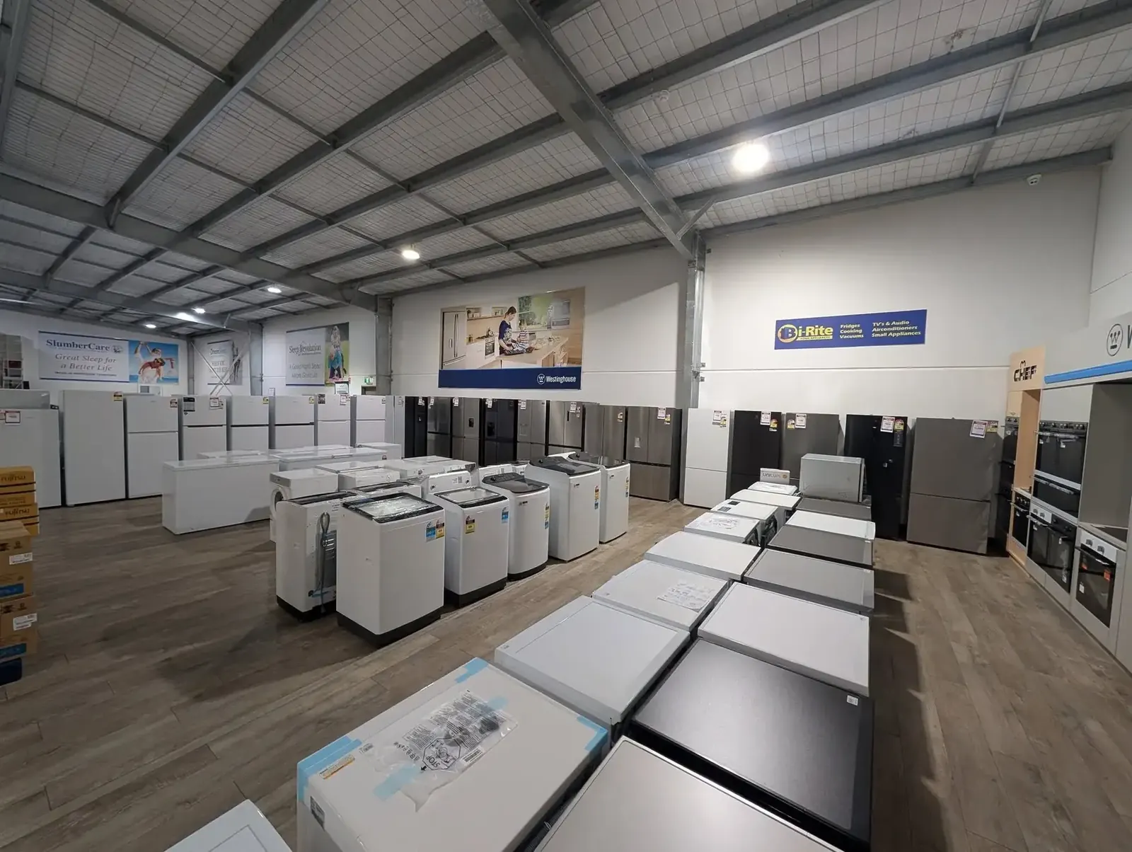 Fridges, freezers and washing machines lined up in the appliance showroom - Whitehouse Furnishers, Katherine