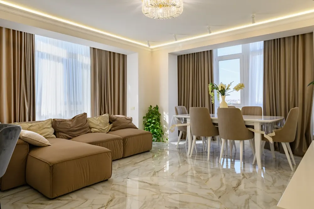 Floor-to-ceiling curtains and sheer blinds framing windows in a bright living space - Whitehouse Furnishers, Katherine