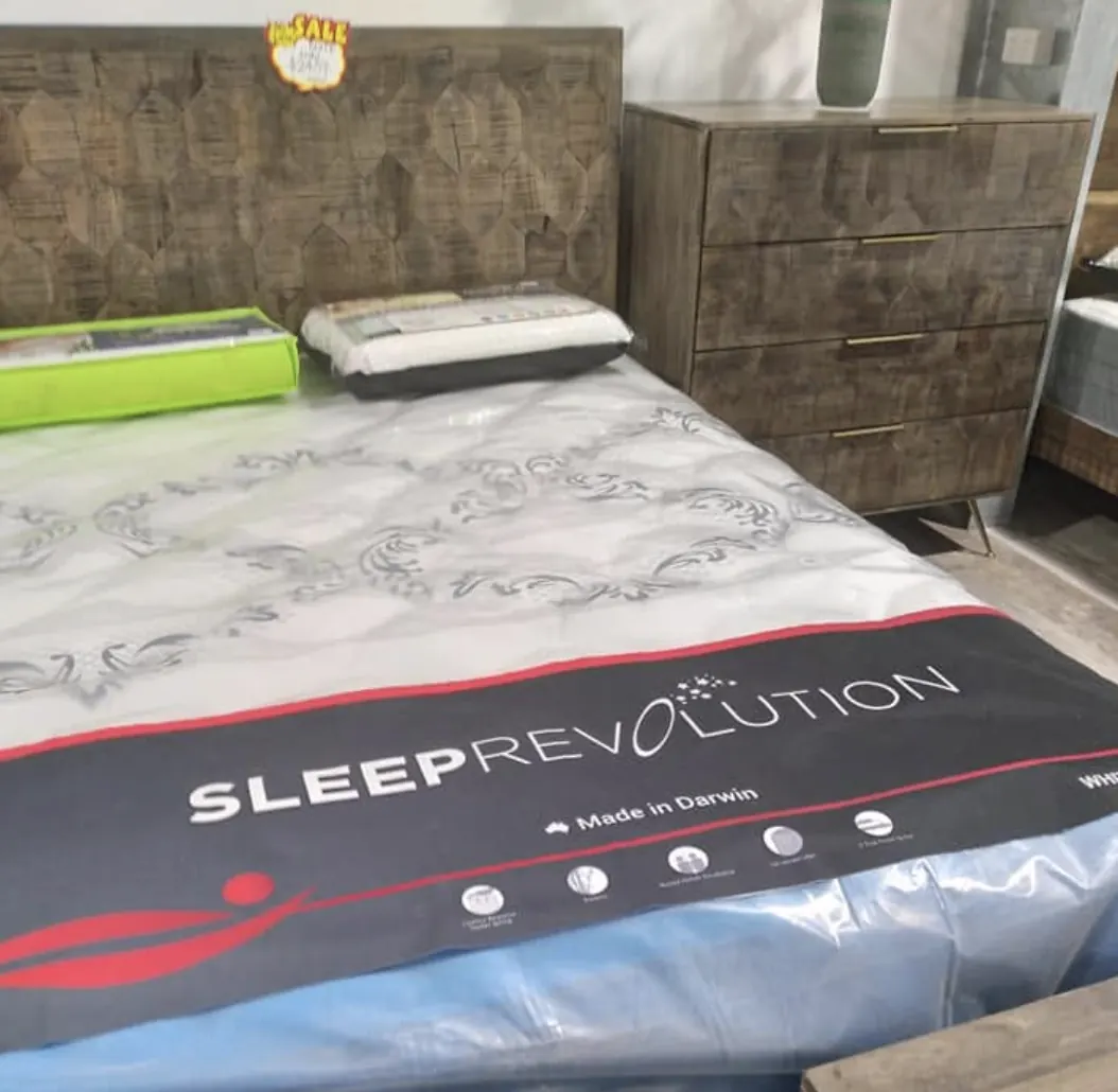 Timber bed frame with a Sleep Revolution mattress beside a matching tallboy - Whitehouse Furnishers, Katherine